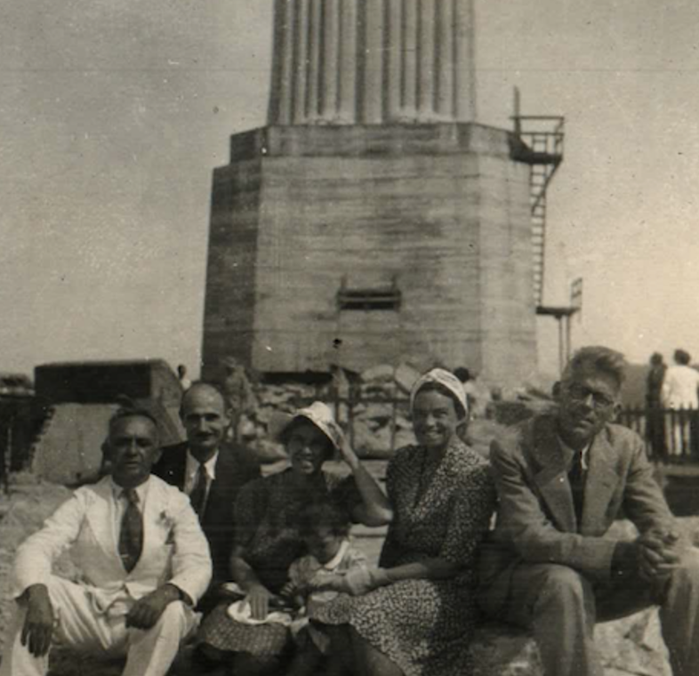 People sitting at base of a statue