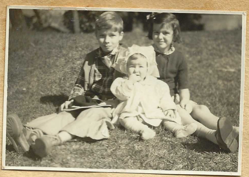 Siblings sitting in grass